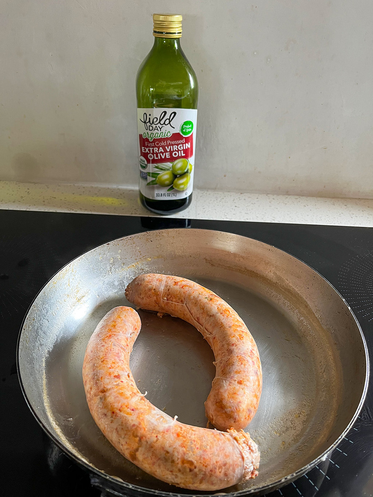 Sausage having been boiled in white wine before being browned